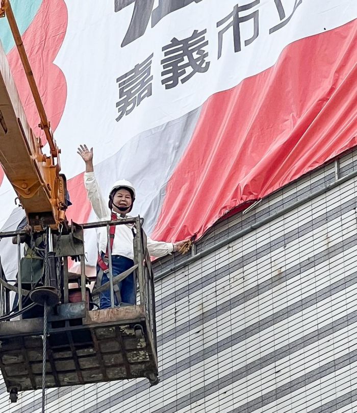 立委參選人張秀華競選首面大型看板　搭高空吊車升6層樓高掛看板